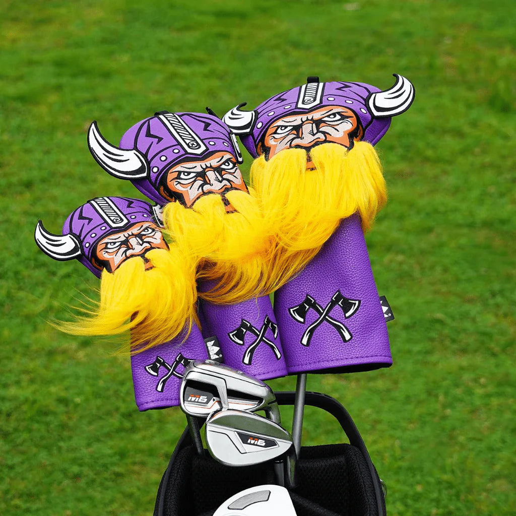 Viking-themed golf club covers with purple hats and yellow beards on a grass background